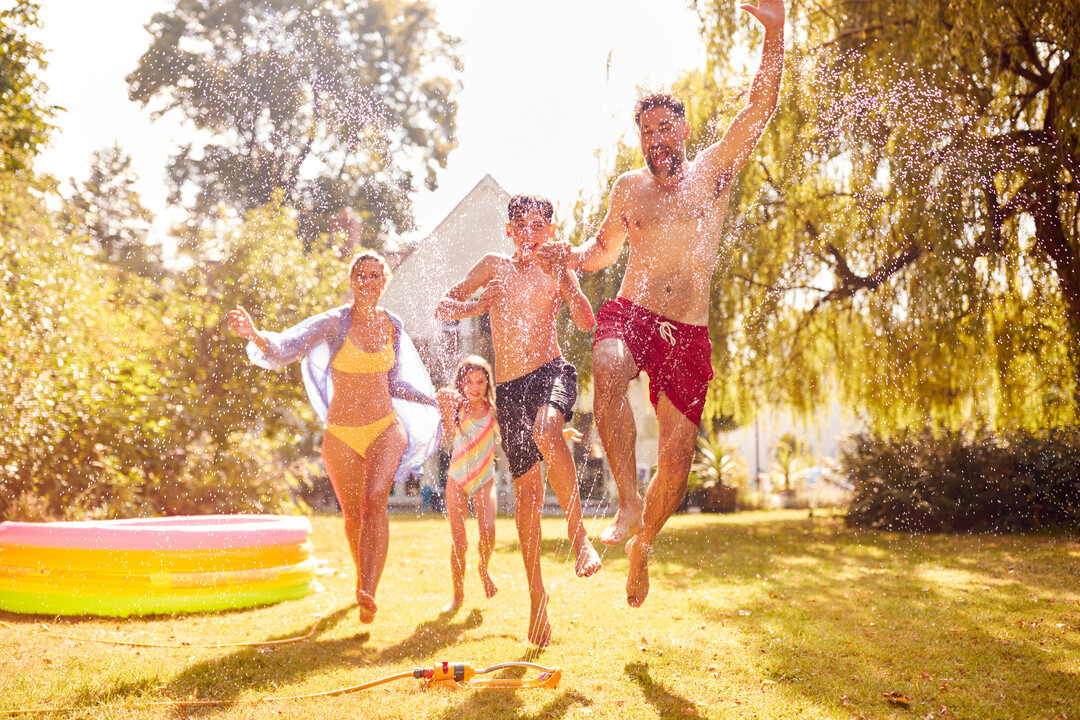 a happy family enjoying summer in the lawn