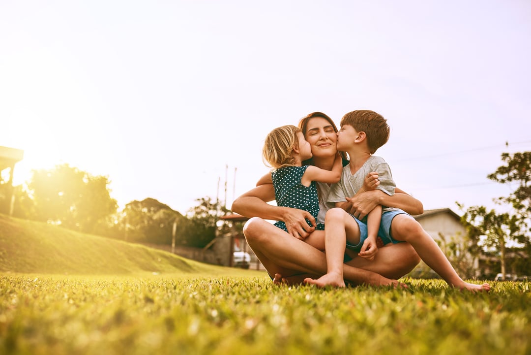 a happy family enjoying the healthy lawn