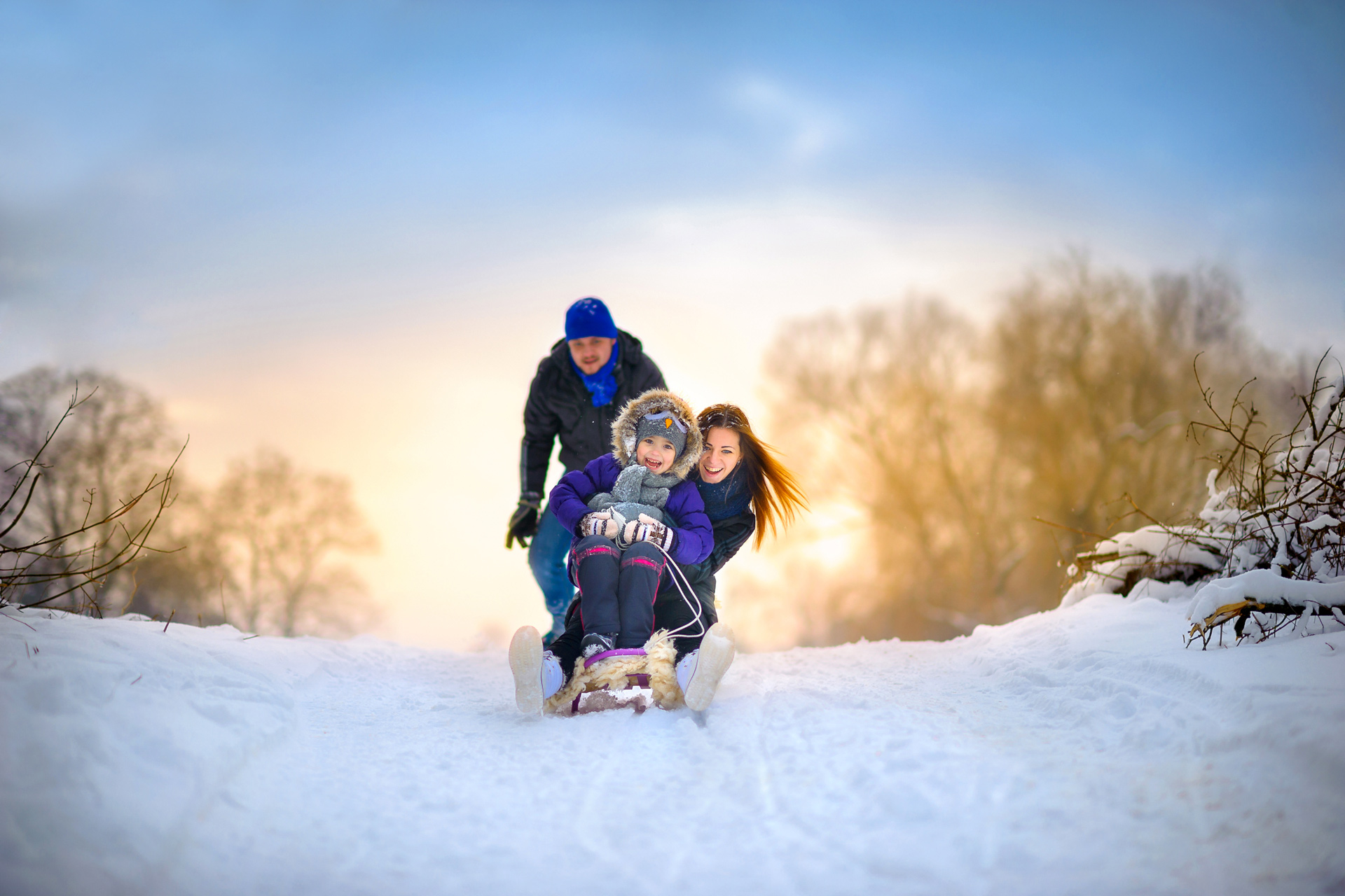 Family Enjoying the Snow on a Snow Sled